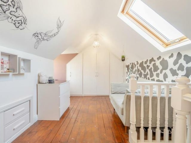 At the top of the stairs sits this fifth and final bedroom, with access to eaves storage on two sides. As well as a Velux roof window, there is a dormer window overlooking the back of the Robin Down Lane property.