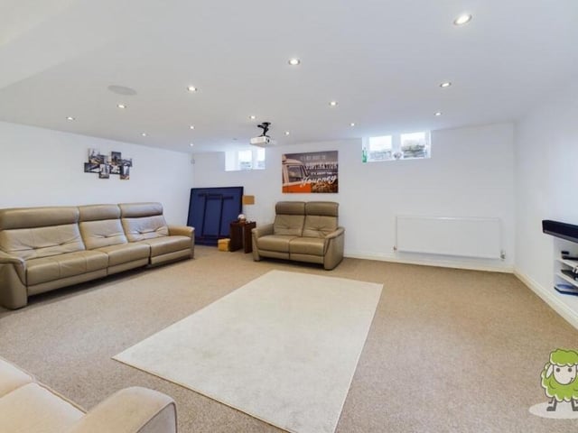 Let's drop down a level now to the lower ground floor at the Forest Town house. It reveals a sprawling multi-functional room, currently operating as a cinema, lounge and games room, with an office and two store rooms attached.