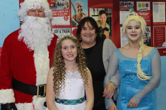 Children were entertained by Disney princesses and got a gift from Santa