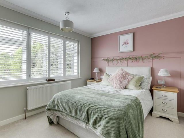 Of the two double bedrooms at the £260,000 bungalow, this is the main one and the largest. A bright and beautifully presented space, it is blessed with a large window overlooking the front, a panelled feature wall and carpeted floor. The window is fitted with bespoke shutters.