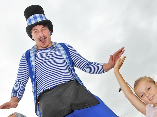 9 year old Poppy Richards, from Kirkby, give high fives to Joker Entertainment's Blake Murray.