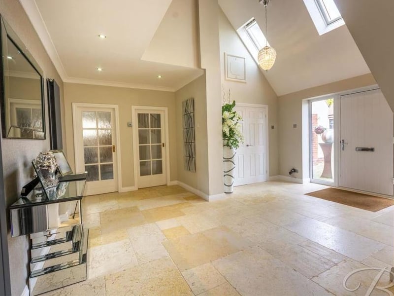 As we prepare to go upstairs, let's pass through the spacious and salubrious entrance hallway. Skylights allow natural light to flood in.
