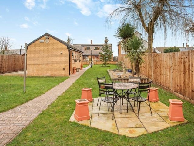 Beyond the outbuilding is another pleasant seating area, underlining the terrific size of the back garden. This is a relaxing spot during the summer.
