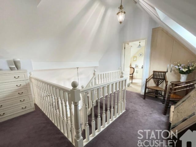 At the top of the stairs, you are welcomed by this attractive gallery landing, with has a Velux window facing the rear of the house and also built-in storage space.