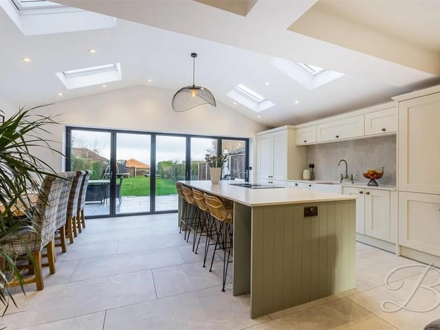 Stunning open plan kitchen/diner complete with a modern range of cabinets with complementary work surface over, inset sink and drainer, and an integrated double oven and hob. Windows and bi-folding doors to rear elevation.