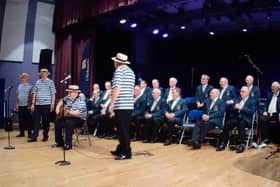 Alfreton Male Voice Choir members with its Sagalouts contingent in front of the microphones.