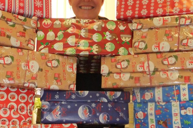 Ali Baker, PA to the CEO/Chairman & Office Manager, at Derbyshire Healthcare NHS Foundation Trust with the shoeboxes collected for Operation Christmas Child in 2012