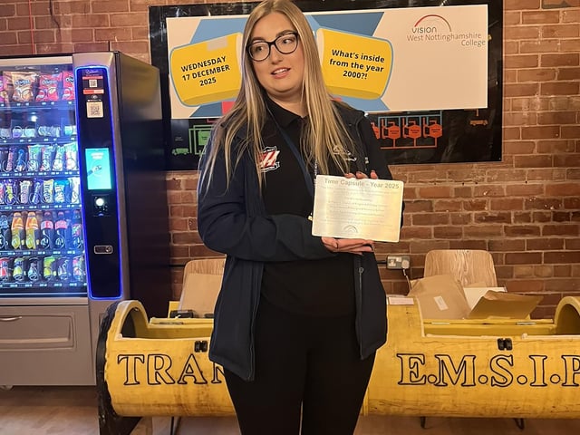 Engineering technician Kacey Gilberthorpe with a new plaque to commemorate the event.