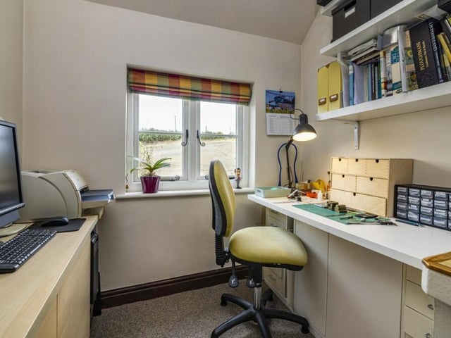 The third bedroom is a versatile space that could be put to multiple uses. At present, it is a fully functional home office.