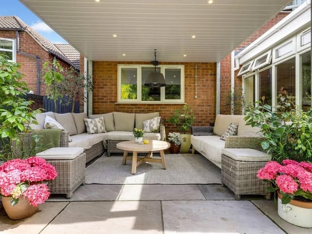 The garden features a superb covered outdoor living area fitted with recessed spotlights, power points, an electric heater and ample space for lounge furniture, making it ideal for year-round entertaining.