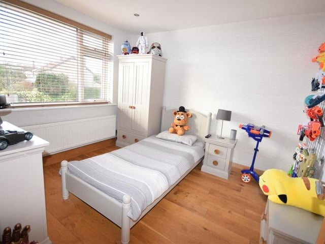 The fact that this one has been modified for a child underlines the versatility of the four bedrooms. It has solid oak flooring, downlighting, a radiator and a window overlooking the front of the house.