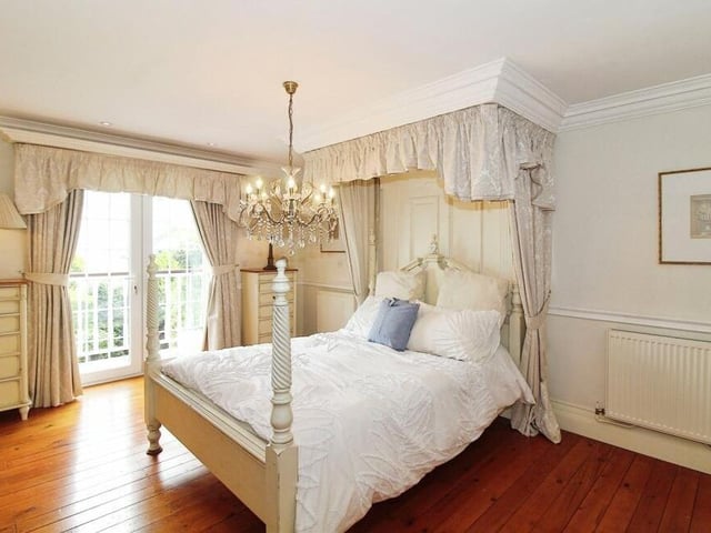 A second look at the main bedroom, complete with the French doors that lead out to the balcony.