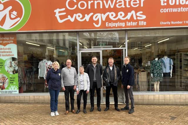 photo of Ben Bradley outside the Charity shop in Mansfield town centre alongside volunteers from the