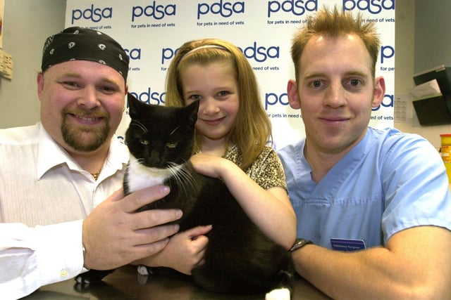 Marble the cat was returned to her owners after vet, Mike Squires, right removed an air gun pellet from her bladder in 2002, pictured with  7-year-old Alina Wall and dad Martin Wall from Barnsley  are pictured at the pet aid hospital on Newhall Rd, Newhall, Sheffield.
