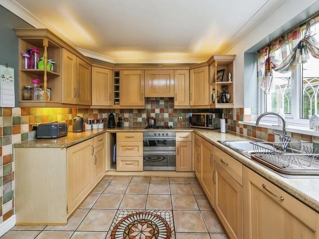 The good-sized kitchen is fitted with wall and base units, incorporating a stainless steel sink and drainer. Integrated appliances include an electric double oven, Ariston gas hob with extractor hood over, Ariston fridge and freezer and Ariston dishwasher. There is also a fitted wine-rack and tiled flooring.