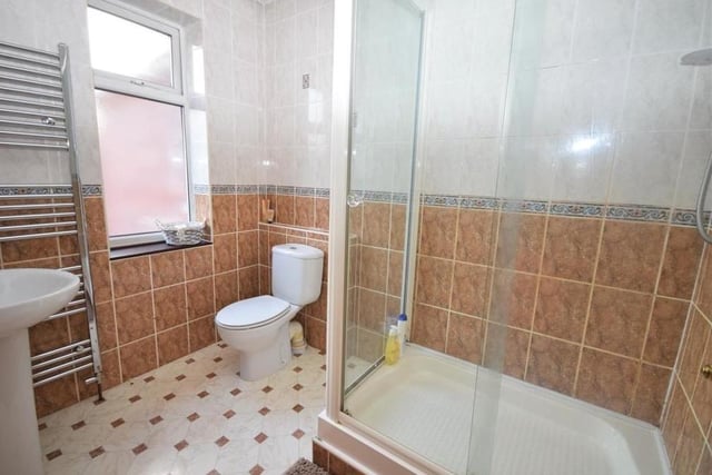 The Ravenshead property features three shower rooms, either as a separate entity (on the ground floor) or as en suite rooms to bedrooms on the first floor. This one has a shower cubicle, low-flush WC, wash basin, chrome heated towel-rail, tiled walls and a tiled floor.