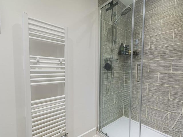 The en suite to the main bedroom also includes a walk-in shower cubicle.