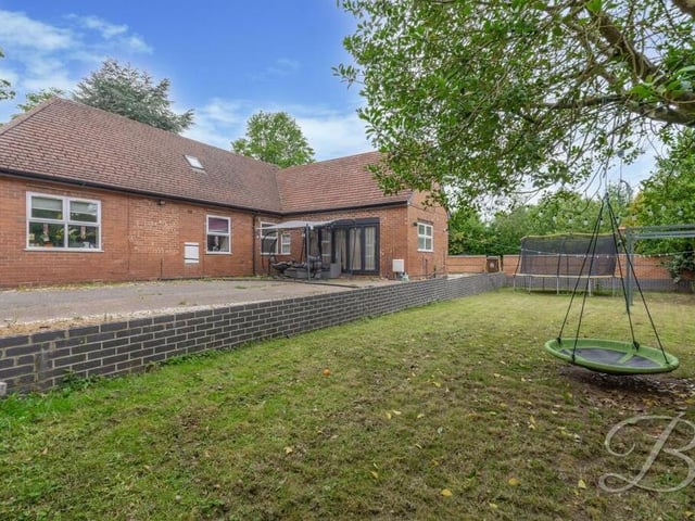 The back of the bungalow features a decked seating area, as well as a lawned garden.