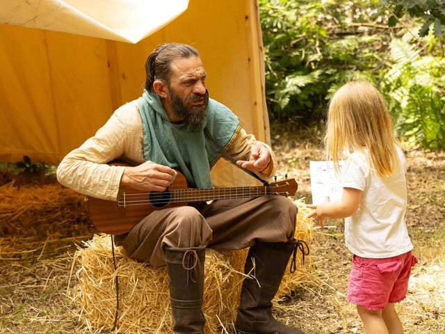 Alan A Dale greets a young visitor to Sherwood Forest on Sunday, July 30.