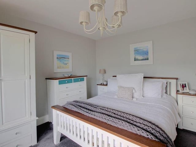 The main bedroom is sizeable and comfortable, complete with a feature window. There is plenty of room for wardrobes and storage too