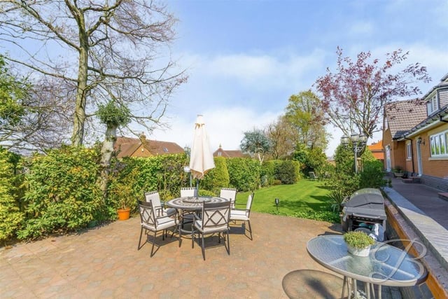 Let's complete our tour of the £1.2 million house by stepping outside for a moment. The expansive garden features this decked seating area, which would be hugely inviting on a warm summer's evening or weekend.