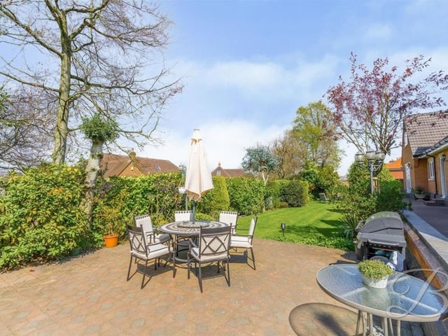 Let's complete our tour of the £1.2 million house by stepping outside for a moment. The expansive garden features this decked seating area, which would be hugely inviting on a warm summer's evening or weekend.