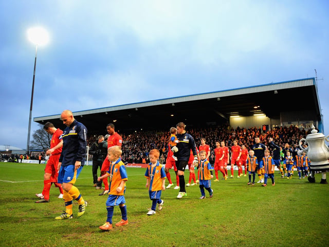 Adam Murray leads Mansfield out for the famous FA Cup third round match with Liverpool. Stags put in a brilliant performance before being cheated out of a replay by a Luis Suarez handball. The defeat signalled better times were on the way for Stags.