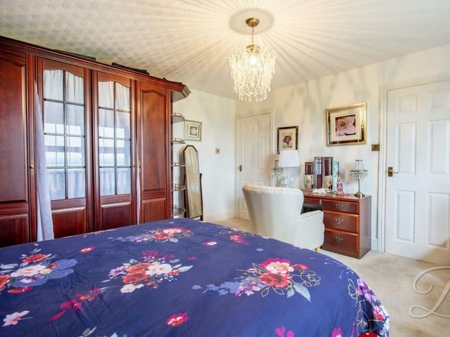 The master bedroom boasts large fitted wardrobes and lots of space for a dressing table or desk, and furniture.