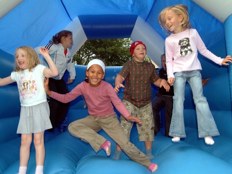 Children enjoyed the bouncy castle at the Saplings Summer Play Scheme fun day held at St Peter and St Paul Church on Ruffs Drive in Hucknall, 2007.