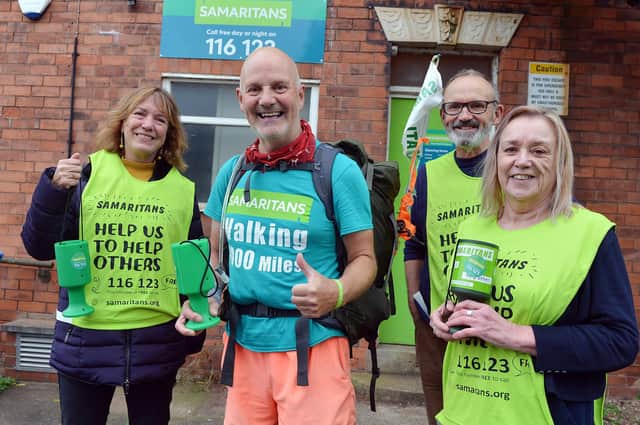 Charity walker David Matthews is greeted by volunteers Tim, Kris and Jane at the Mansfield branch of the Samaritans..