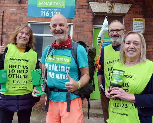 Charity walker David Matthews is greeted by volunteers Tim, Kris and Jane at the Mansfield branch of the Samaritans..