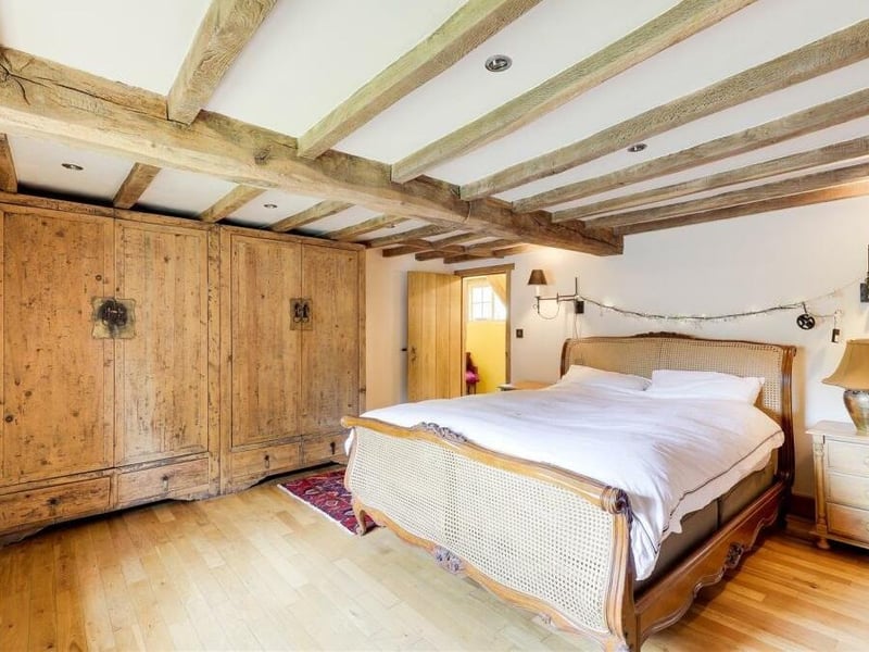 The master bedroom, with its exposed oak beams to the ceiling and solid-oak floor, also boasts plenty of wardrobe space.