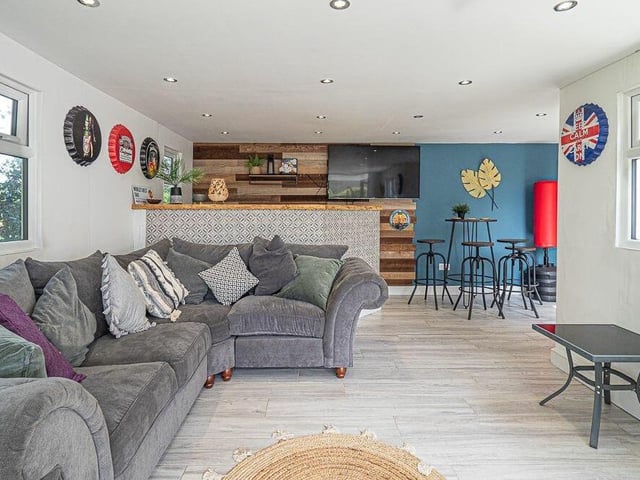An exclusive look inside the plush bar and games room, which is equipped with sofas, stools and tables, TV points, a dart board, and a bar with electricity to power the beer and wine fridges.