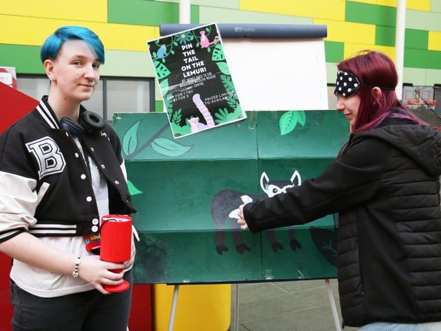 Sparrow Riley and Katie Adey set up the pin the tail on the lemur game.