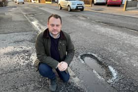 Coun Jason Zadrozny, leader of the Ashfield Independents, next to a dangerous pothole on High Pavement in Sutton.