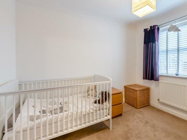 This fourth bedroom, which is the smallest on the first floor, is currently set up for a young child. But it also has fitted wardrobes with hanging rails and shelves.