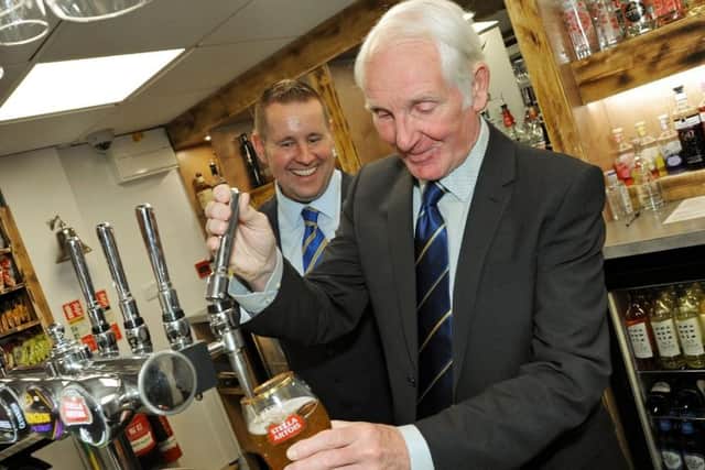 Club legend Sandy Pate pulling a pint in the bar named after him when it was re-opened following refurbishment