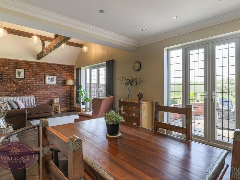 The kitchen flows seamlessly into this dining room which, in turn, adjoins a family room or extra living space.
