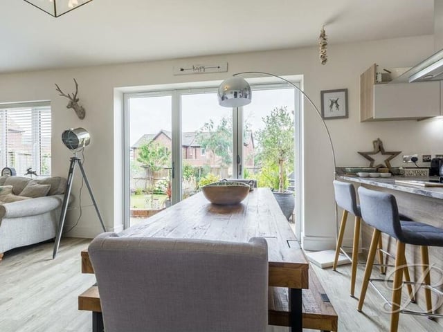 Sitting next to the breakfast bar is the dining section of the open-plan space. There is room for a table for sit-down meals, complemented by bi-folding doors that lead out to the rear garden.