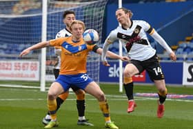 Mansfield's George Lapslie battles with Newport's Aaron Lewis.