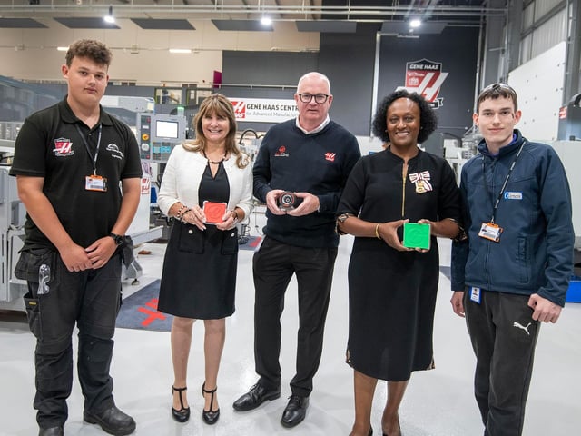 Student George Colley (left) and apprentice Nikita Romancevics (right) pictured with Kathy Looman, Professor Veronica Pickering, and Andrew Ward, director of Haas Automation UK (centre), who received Haas-branded items made by learners using the machines.