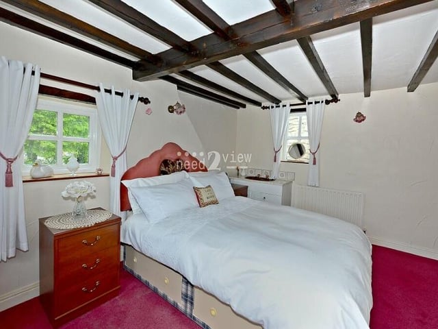 The main bedroom has fitted wardrobes and also a wash hand basin, built into a vanity unit.