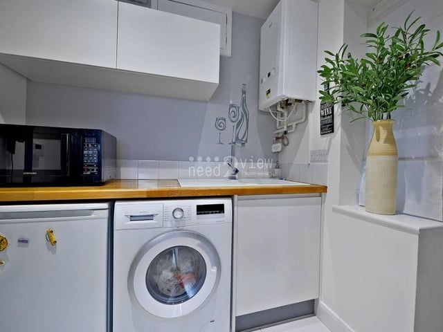 Close to the kitchen and dining area is this useful utility room, which has space and plumbing for a washing machine and a fridge freezer. It is fitted with white wall and base units and a single drainer sink with chrome mixer tap.