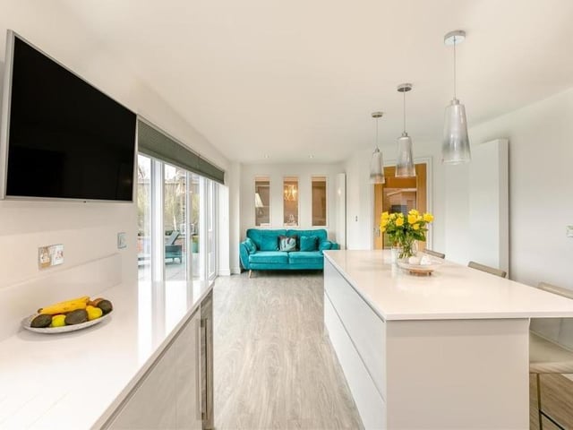 The kitchen also features a living area at the far end, with room for a sofa.