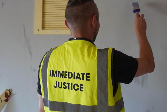 A Immediate Justice service user painting the community centre.