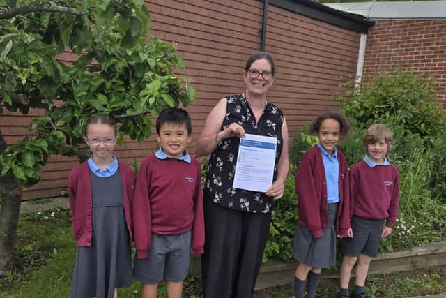 Pupils and staff celebrate a positive Ofsted report. Pictured Headteacher Aly Speed with Year Two pupils Layla, Alexander, Riley and Theo.