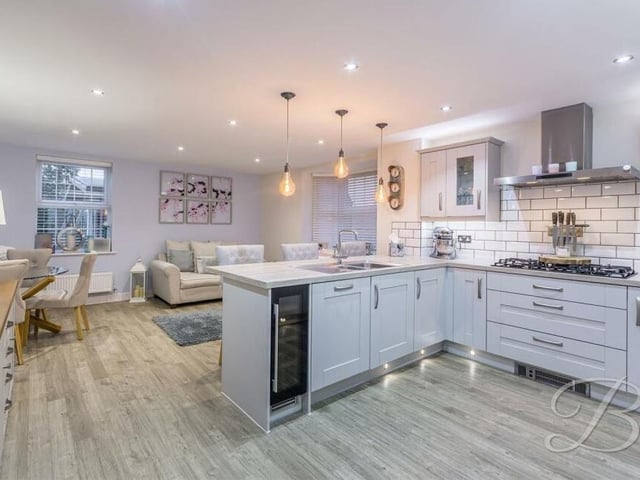 The kitchen features a host of integrated appliances, providing the perfect setting for those who love to cook. Spotlights add to its brightness.