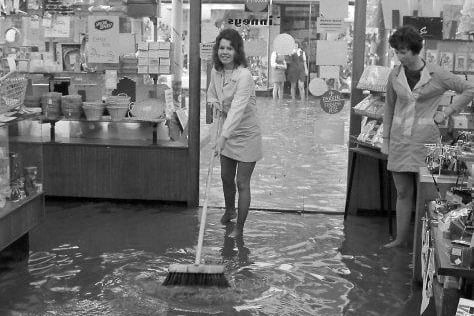 16-year-old Karen Ball swept the flood water at Linneys on Westgate.