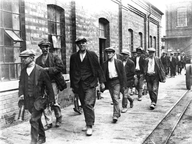 Miners from the colliery at Crown Farm near Mansfield on their way home from work on 1st August 1926.