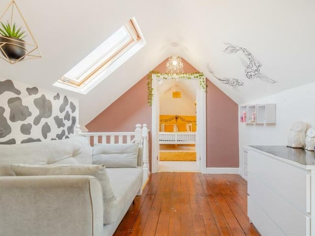 The dormer bedroom includes a dressing area with fitted wardrobes that have hanging rails.